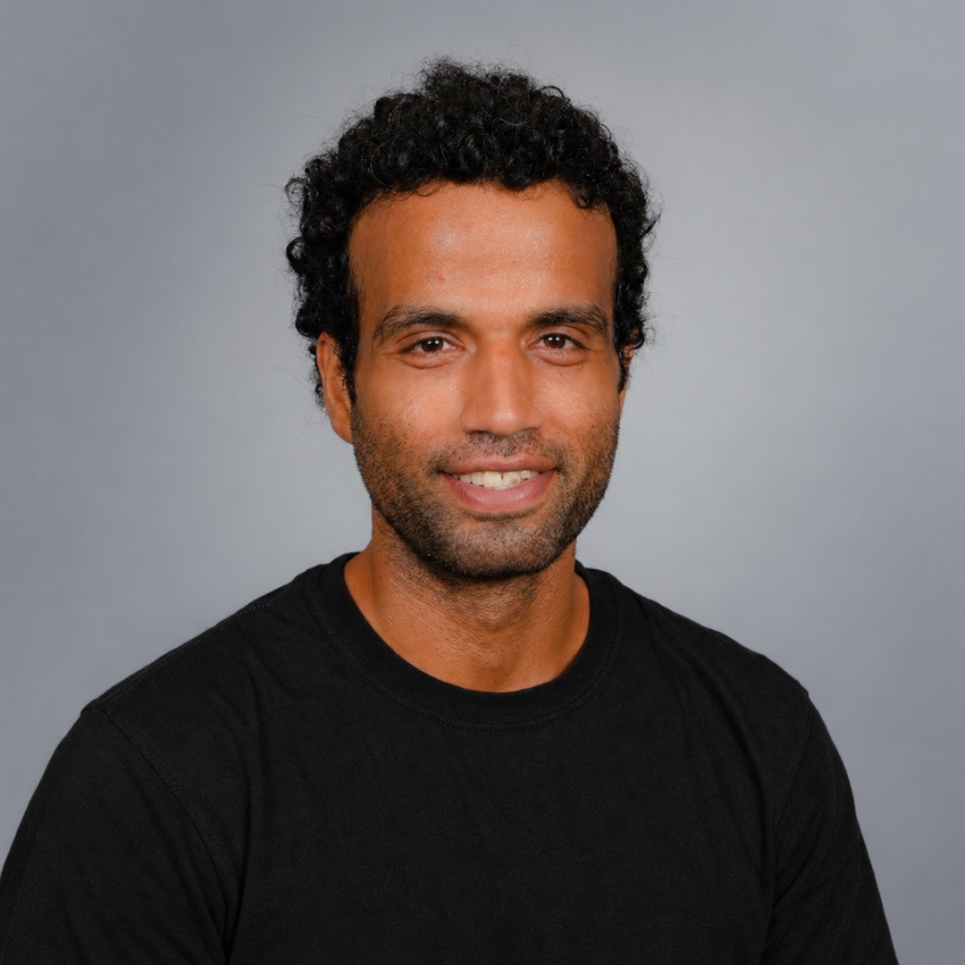 Portrait of Dr. Nawaf Mohammed wearing a black shirt against a gray background.